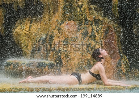 one woman bathing at ma\'in hot springs waterfall in Jordan middle east