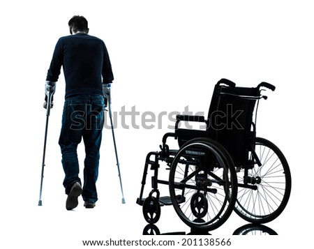 one man injured man walking with crutches in silhouette studio on white background