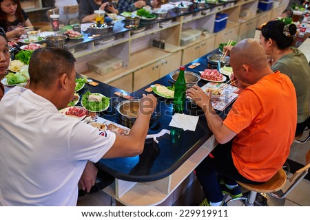 Beijing , China - September 24, 2014: people eating Chinese Hot pot in a restaurant in Beijing China