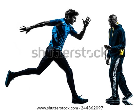 one  man running sprinting with coach stopwatch in silhouette studio isolated on white background