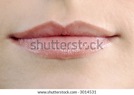 studio shot close up detail of the face of a beautiful young women with perfect lips mouth and teeth smiling