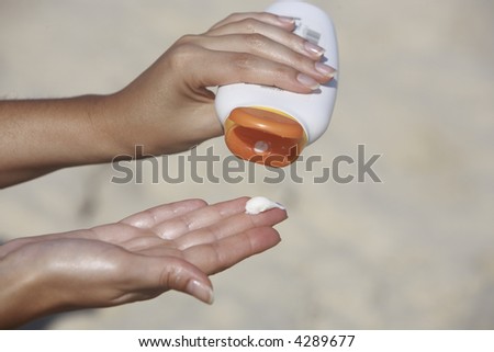close up of hands receiving sunblock lotion