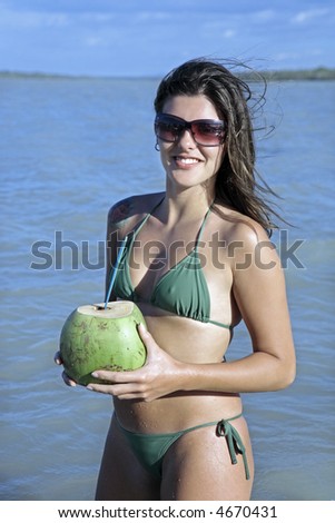 brazilian flag bikini. stock photo : beautiful smiling ikini dressed young razilian woman drinking and holding fresh coconut juice