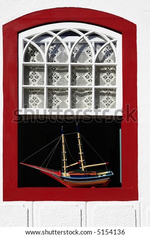 boat model at a window of the beautiful portuguese colonial typical town of parati in rio de janeiro state brazil