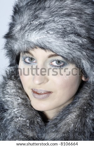 studio shot portrait of a beautiful woman russian type in a fur coat and hat