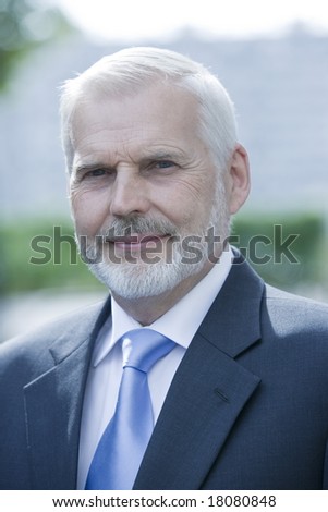 expressive portrait of a handsome senior businessman on isolated background