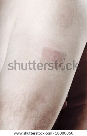 nicotine patch on one man arm