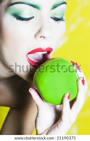 beautiful woman portrait with colorful make-up  and background holding apple
