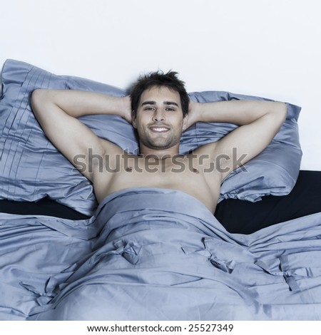 handsome man in a bed on isloated background