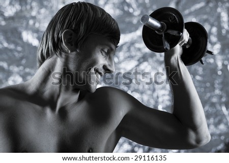 studio portrait of handsome blond man torso naked doing workout