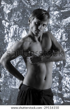 studio portrait of handsome blond man torso naked doing workout