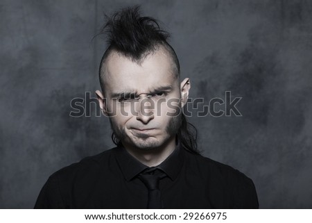 studio expressive portrait of a young punk man hansome on isolated background