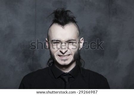 studio expressive portrait of a young punk man hansome on isolated background