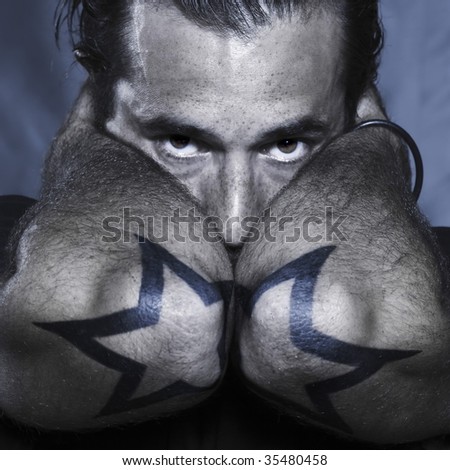 stock photo studio shot portrait of a urban stylish man with stars tattoos