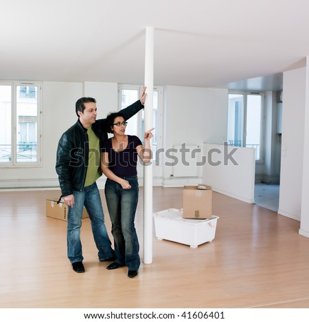 couple inside an empty loft apartement moving in