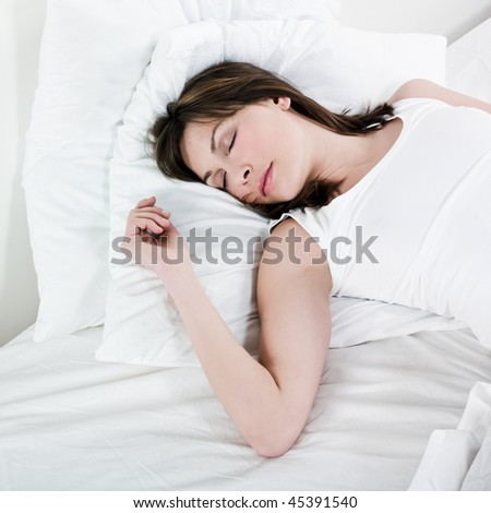 woman lying on a white bed