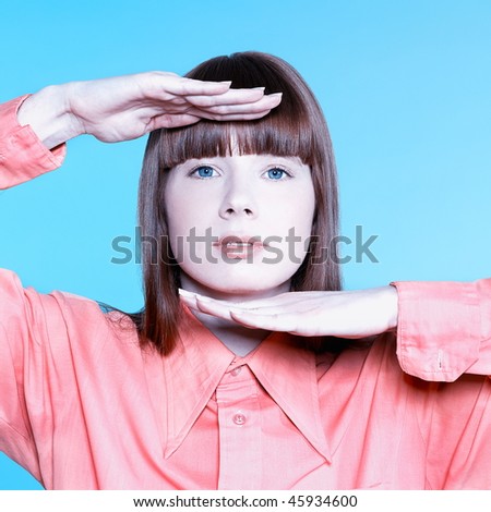 studio portrait of a young woman on isolated background framing fac