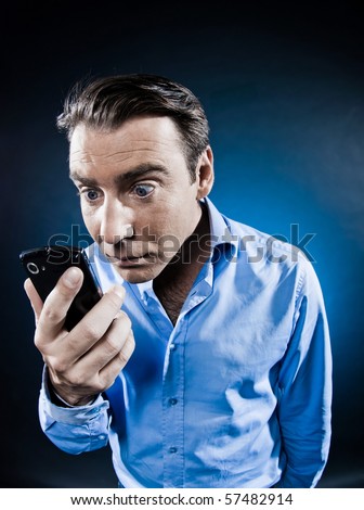 caucasian man staring cellphone portrait isolated studio on black background