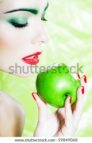 beautiful woman portrait with colorful make-up  and background holding apple