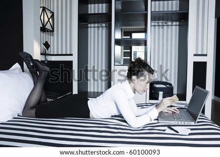 beautiful caucasian woman internet payment hold credit card in a hotel bedroom