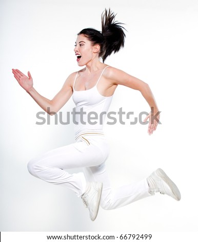 beautiful young woman on studio isolated white background doing her workout run leap