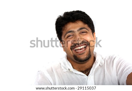stock photo A handsome Indian man laughing on white studio background