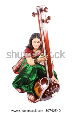 A female Indian classical singer smiling beautifully, on white studio background.