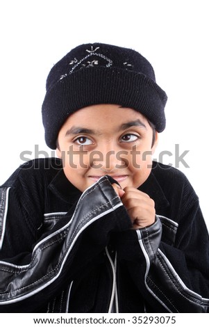 A portrait of a cute Indian boy in winter clothes feeling cold, on white studio background.