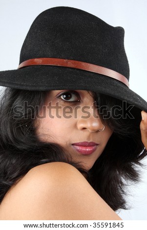 stock photo A portrait of an Indian babe wearing a black fedora hat