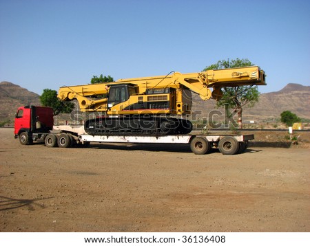 A huge truck carrying a crane.