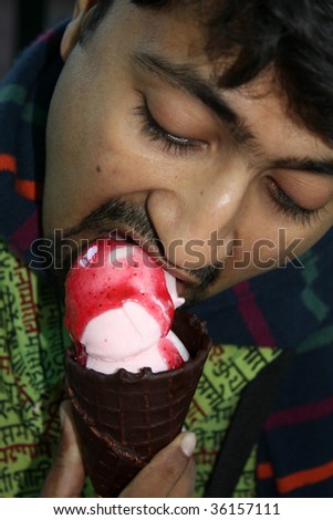 stock-photo-an-indian-man-eating-fresh-amp-delicious-strawberry-ice-cream-in-a-chocolate-waffle-cone-36157111.jpg