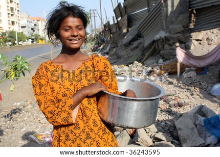 A poor Indian streetside hungry teenager showing her empty vessel.