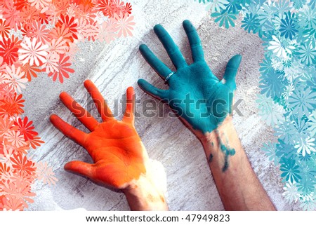 Hands colored with Holi festival colors, with a floral pattern around.
