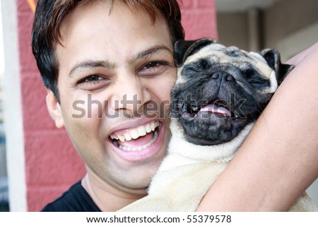 A laughing guy with his PUG pet dog, which also appears to be laughing.