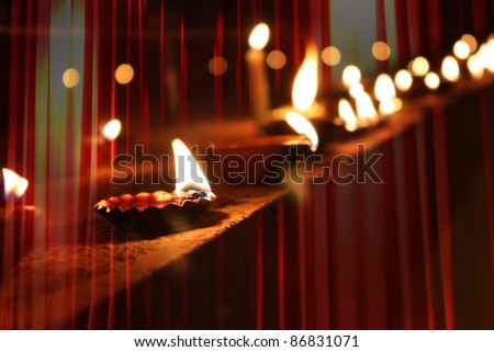 Beautiful diwali lamps traditionally lit on the occasion of Diwali festival in India with beautiful red light streaks Beautiful diwali lamps traditionally lit on the occasion of Diwali festival in India with beautiful red light streaks