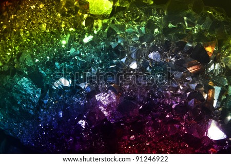 A background of a precious crystal background lit in different colors.