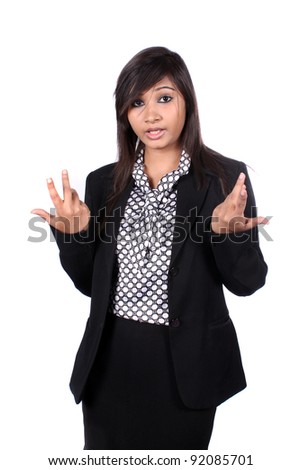 A young beautiful Indian female executive asking a question, on white studio background.