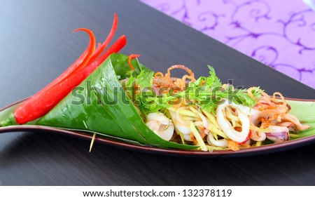 green mango and squid salad with dry shrimp dressing - stock photo