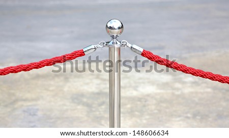 single bronze stanchion with velvet ropes.
