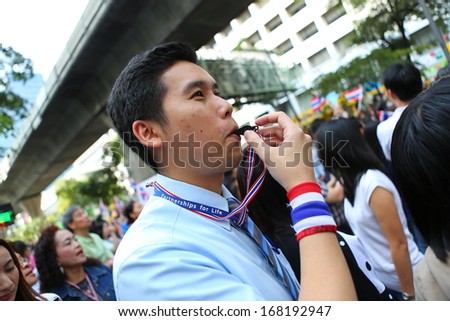 BANGKOK,THAILAND - DECEMBER 20: Employees at Silom neighborhood  whistle for anti-government. The protest Against The Amnesty bill in Bangkok, capital of Thailand on 20 December 2013
