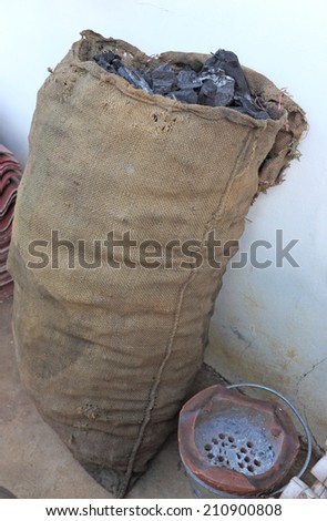 wooden charcoal in sacks with old stove