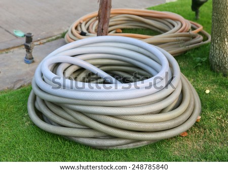water hoses lie on the garden