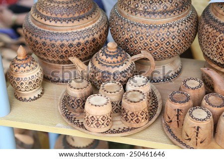 Teapot and cup made of wood brown on the market