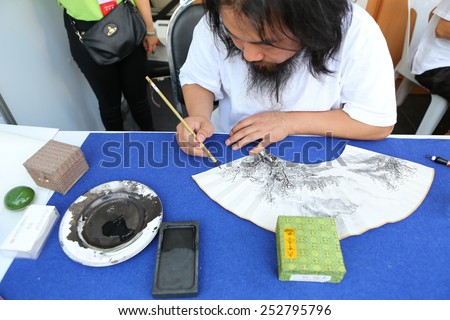 BANGKOK, THAILNAD - FEBRUARY 14: An unidentified Chinese artist painting in art souvenir at Central World Plaza during the Chinese New Year celebrations on February 14, 2015 in Bangkok, Thailand