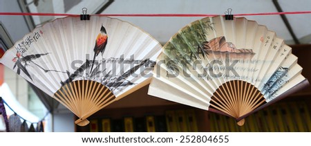 BANGKOK, THAILNAD - FEBRUARY 14: Painted on Chinese paper fan on sale at Central World Plaza during the Chinese New Year celebrations on February 14, 2015 in Bangkok, Thailand