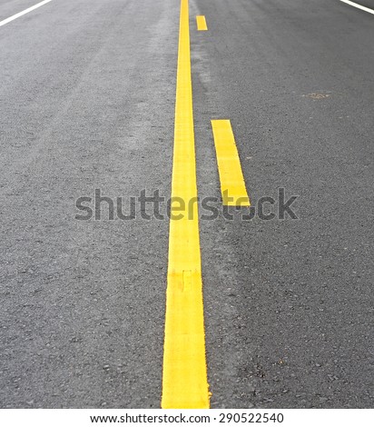 yellow lines on an asphalt road-narrow depth of field