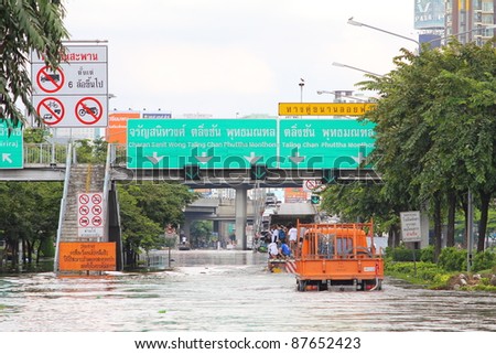 BANGKOK, THAILAND - OCTOBER 29 : Unidentified people sit and stand in big truck to escape rising flood waters at Pinklao Bridge, in Bangkok, Thailand on Oct. 29, 2011.