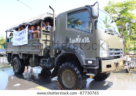 BANGKOK THAILAND - OCTOBER 30 : Unidentified people stand in big truck to escape rising flood waters at Vipavadeerangsit Road Donmuang domestic airport, in Bangkok, Thailand on Oct. 30, 2011.