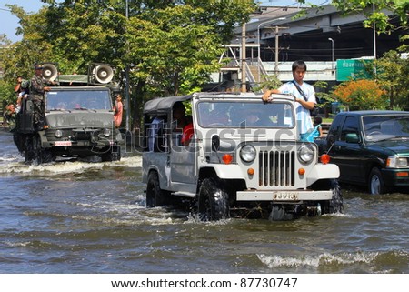 BANGKOK THAILAND - OCTOBER 30 : Unidentified people sit and stand in big truck to escape rising flood waters from monsoon rain at Vipavadeerangsit Road Donmuang domestic airport, in Bangkok, Thailand on Oct. 30, 2011.