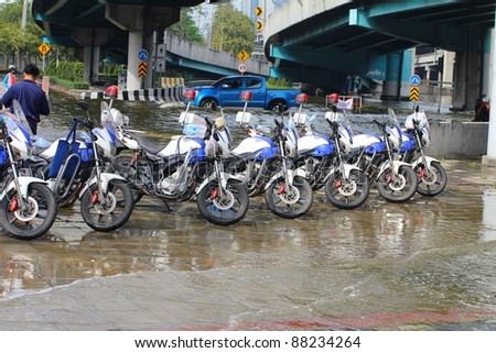 BANGKOK THAILAND - NOVEMBER 5 : Motorcycle of traffic police, Heavy flooding from monsoon rain from north Thailand arriving in ladprao Road junction on November 5, 2011 in Central Bangkok, Thailand.